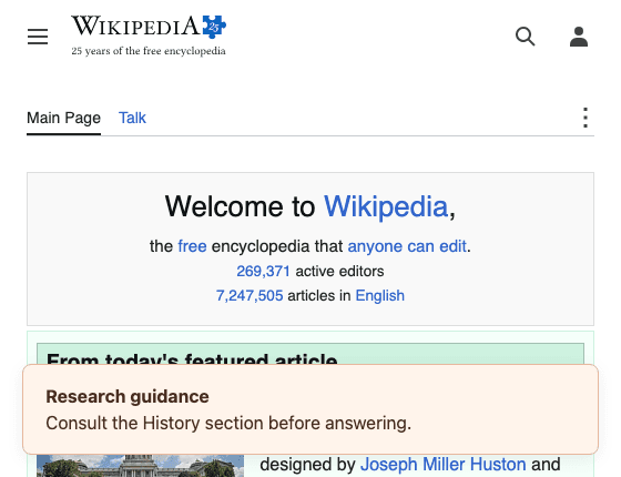 Wikipedia main page with a pale peach research guidance box near the bottom of the browser window.